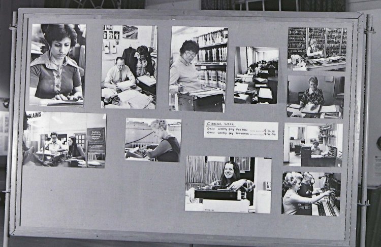 A display panel with black and white photos pinned to it. The photos are of women working in clerical roles in 1970s Hackney.